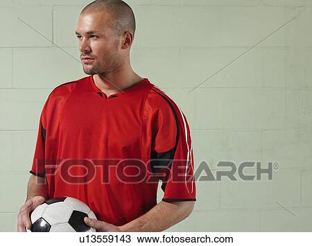 Soccer player holding ball, portrait View Large Photo Image Stock Image - Soccer player holding ball, portrait. Fotosearch