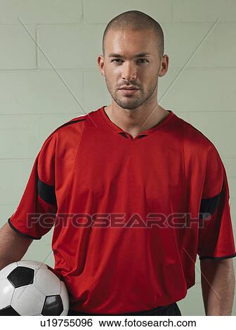 Soccer player holding ball, portrait View Large Photo Image Stock Photograph - Soccer player holding ball, portrait. Fotosearch