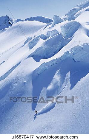 Solitary snowboarder on steep slope View Large Photo Image Stock Photo - Solitary snowboarder on steep slope. Fotosearch