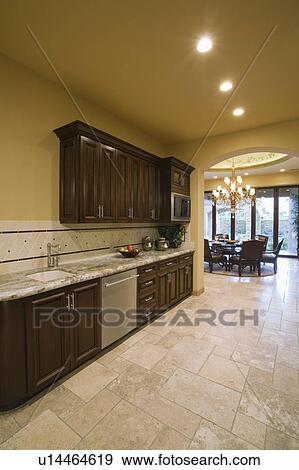 Spacious kitchen with dark wood fitted units View Large Photo Image Stock Photo - Spacious kitchen with dark wood fitted units. Fotosearch