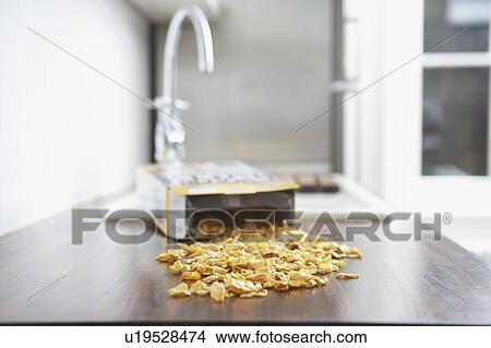 Picture - Spilled cereal on kitchen counter. Fotosearch