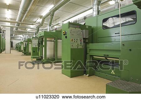 Stock Image - Spinning factory machinery. Fotosearch