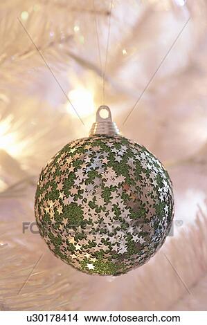 Star covered Christmas bauble hanging on tree, close-up View Large Photo Image Picture - Star covered Christmas bauble hanging on tree, close-up. Fotosearch