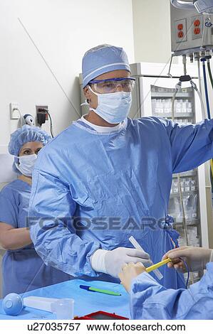 Stock Photo - Surgeon in operating room. Fotosearch