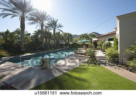 Swimming pool in landscaped grounds View Large Photo Image Stock Image - Swimming pool in landscaped grounds. Fotosearch