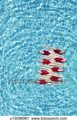Synchronised swimmers balance head-to-toe View Large Photo Image Stock Photo - Synchronised swimmers balance head-to-toe. Fotosearch