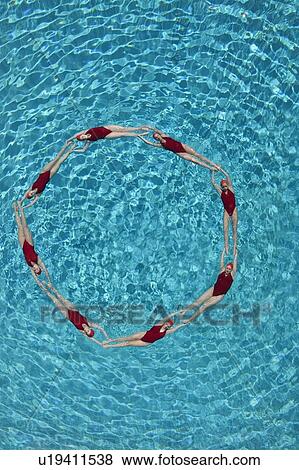 Stock Photo - Synchronised swimmers form a circle. Fotosearch