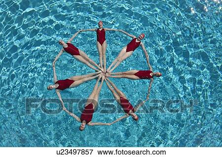 Stock Photo - Synchronised swimmers form a circle. Fotosearch