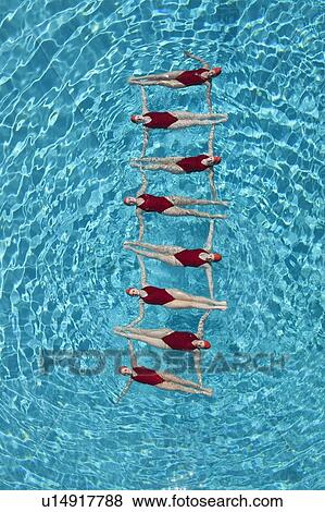 Synchronised swimmers form a ladder View Large Photo Image Stock Photo - Synchronised swimmers form a ladder. Fotosearch