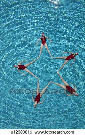 Stock Photography - Synchronised swimmers form a star. Fotosearch