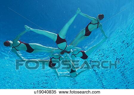 Stock Photography - Synchronised swimmers form a star, underwater view. Fotosearch