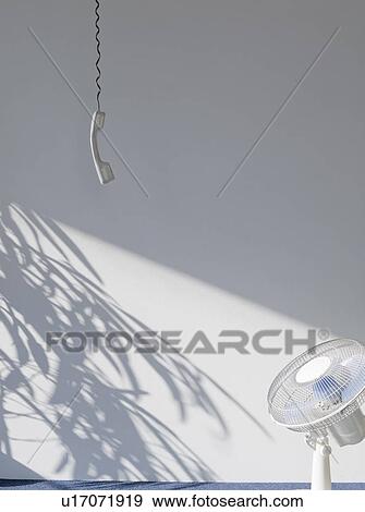 Telephone receiver and fan in empty room View Large Photo Image Stock Photo - Telephone receiver and fan in empty room. Fotosearch