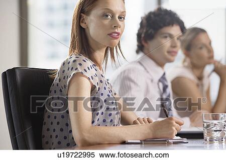 Three businesspeople at business meeting View Large Photo Image Stock Photography - Three businesspeople at business meeting. Fotosearch