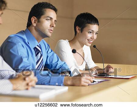 Three businesspeople at Panel Presentation View Large Photo Image Stock Image - Three businesspeople at Panel Presentation. Fotosearch
