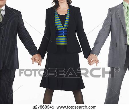 Stock Photography - Three businesspeople holding hands. Fotosearch