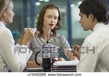 Stock Photo - Three businesspeople taking a coffee break. Fotosearch
