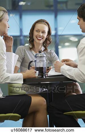 Stock Photo - Three businesspeople taking a coffee break. Fotosearch