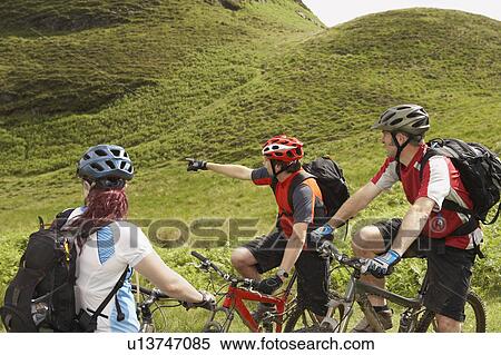 Three cyclists in countryside View Large Photo Image Stock Photography - Three cyclists in countryside. Fotosearch