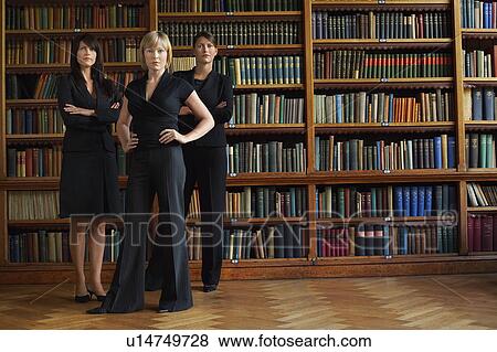 Stock Photo - Three lawyers in library, standing. Fotosearch