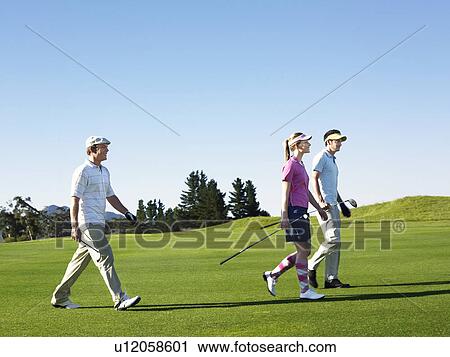 Three young golfers on course View Large Photo Image Stock Image - Three young golfers on course. Fotosearch