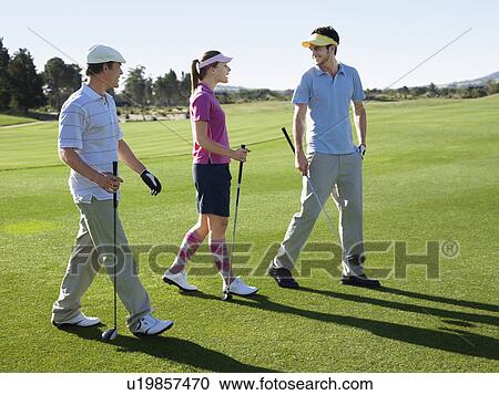 Three young golfers on course View Large Photo Image Stock Image - Three young golfers on course. Fotosearch