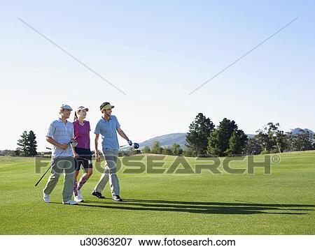 Three young golfers on course View Large Photo Image Stock Photo - Three young golfers on course. Fotosearch