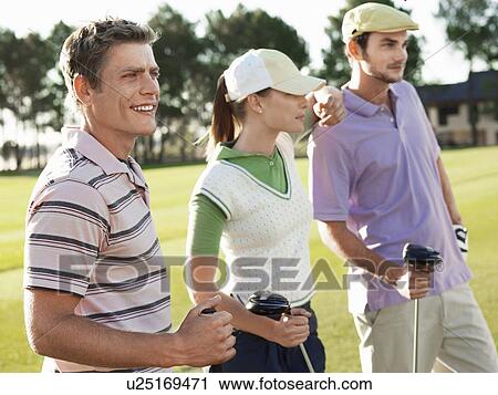 Stock Image - Three young golfers on court. Fotosearch