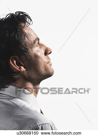 Stock Image - Tired Young Businessman staring into space, profile. Fotosearch
