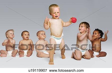 Toddler takes first steps encouragement of other babies View Large Photo Image Stock Photo - Toddler takes first steps encouragement of other babies. Fotosearch