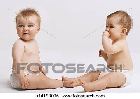 Two Babies looking away View Large Photo Image Stock Photograph - Two Babies looking away. Fotosearch