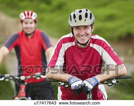 Two cyclists outdoors, portrait View Large Photo Image Stock Image - Two cyclists outdoors, portrait. Fotosearch