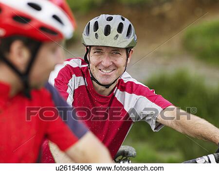 Two cyclists outdoors, portrait View Large Photo Image Stock Photograph - Two cyclists outdoors, portrait. Fotosearch