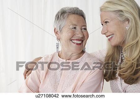 Stock Image - Two elegant senior woman in studio, half length. Fotosearch