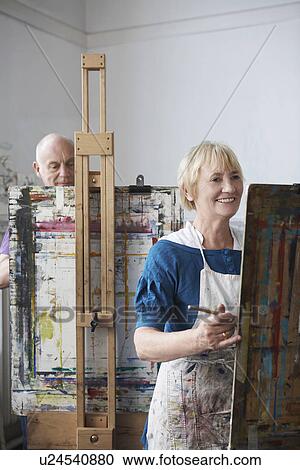 Two mature students painting at easels in art class View Large Photo Image Stock Image - Two mature students painting at easels in art class. Fotosearch
