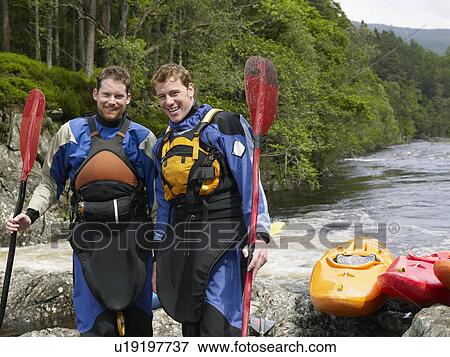 Two men with kayaks by river, portrait View Large Photo Image Stock Photo - Two men with kayaks by river, portrait. Fotosearch
