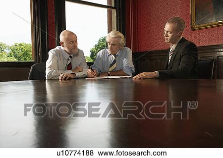 Stock Photo - Two Older Men and One Younger Man in Meeting. Fotosearch