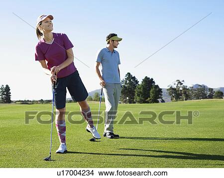 Picture - Two young golfers on course. Fotosearch