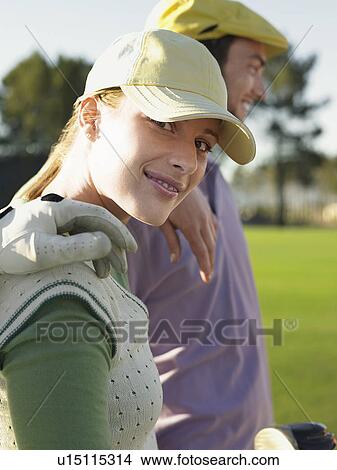 Two young golfers on court, focus on woman View Large Photo Image Picture - Two young golfers on court, focus on woman. Fotosearch