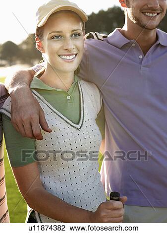 Two young golfers on court, focus on woman View Large Photo Image Stock Image - Two young golfers on court, focus on woman. Fotosearch