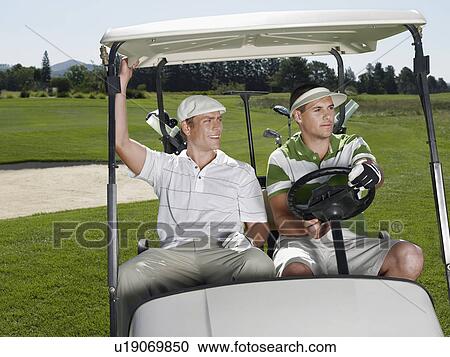 Two young male golfers sitting in cart View Large Photo Image Stock Image - Two young male golfers sitting in cart. Fotosearch