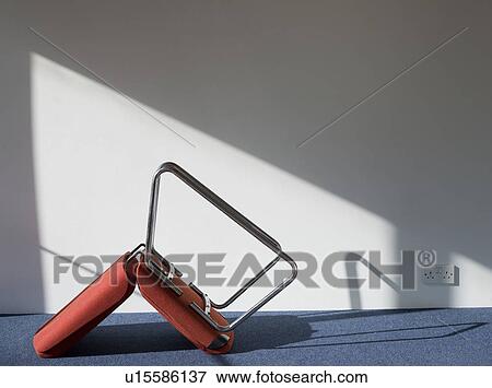 Stock Photo - Upturned office chair casting shadow on wall. Fotosearch