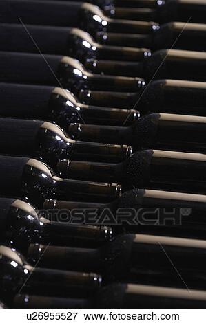 Wine bottles lying down in order View Large Photo Image Stock Photo - Wine bottles lying down in order. Fotosearch
