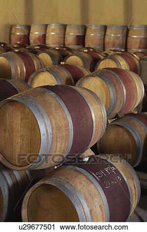 Stock Image - Wine casks in order, standing and lying down. Fotosearch