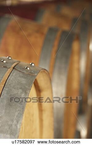 Stock Photo - Wine casks lying down in order, selective focus. Fotosearch