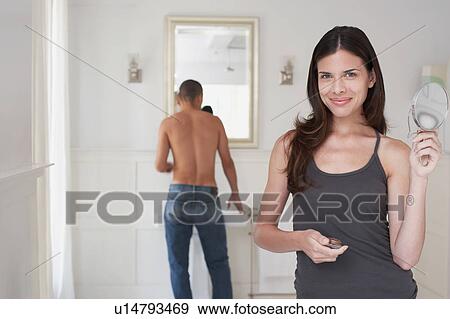 Woman and man getting ready in bathroom View Large Photo Image Stock Photo - Woman and man getting ready in bathroom. Fotosearch