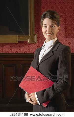 Stock Photo - Woman in Conference Room, standing. Fotosearch