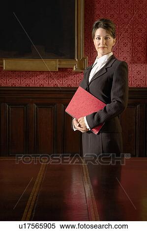Stock Photography - Woman in Conference Room, standing. Fotosearch