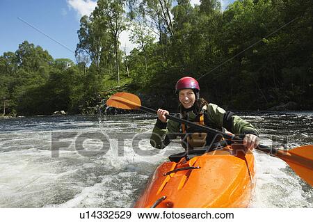 Woman kayaking in river, portrait View Large Photo Image Stock Photo - Woman kayaking in river, portrait. Fotosearch