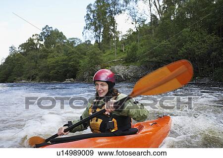 Woman kayaking in river View Large Photo Image Stock Photo - Woman kayaking in river. Fotosearch