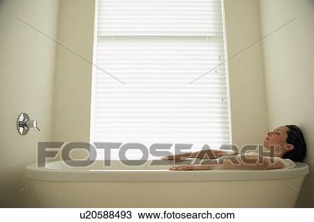 Woman lying in bath tub, side view View Large Photo Image Stock Image - Woman lying in bath tub, side view. Fotosearch